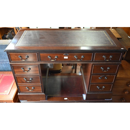 491 - A reproduction mahogany twin pedestal desk with gilt tooled brown leather top over nine drawers (wit... 