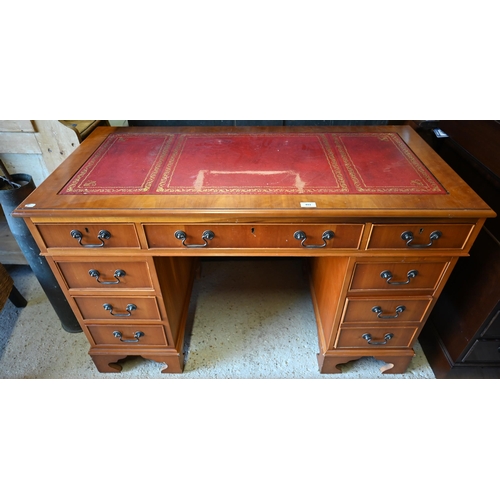 493 - A reproduction cherry finish twin pedestal desk, gilt tooled red leather top over nine drawers, 120 ... 