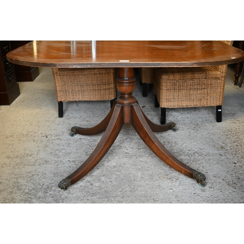 497 - A Regency style mahogany extending dining table with single wide central leaf on twin pedestal quadr... 