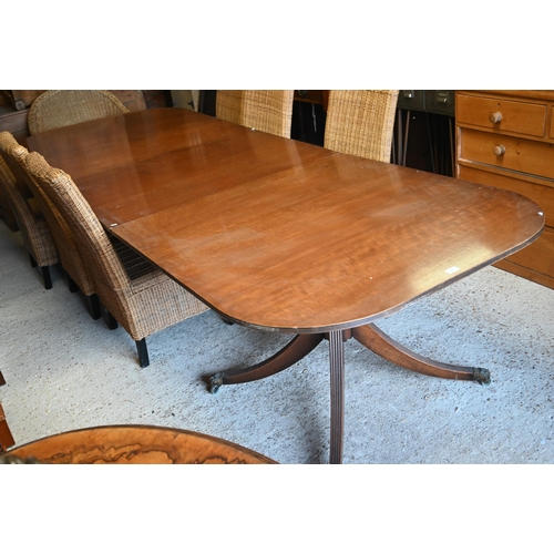 497 - A Regency style mahogany extending dining table with single wide central leaf on twin pedestal quadr... 