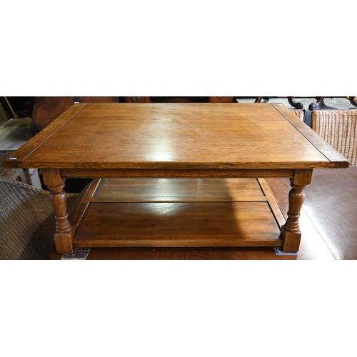 499 - An Ipswich quality large golden oak coffee table, rectangular top on turned supports with open under... 