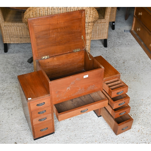 506 - A Chinese carved hardwood sewing cabinet with hinged storage compartment and drawers