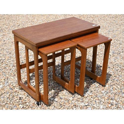 558 - A mid century teak folding tea table with two nesting tables below by McKintosh