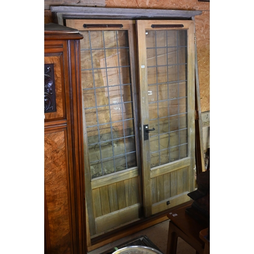 560 - A pair of hardwood lead glazed French doors and frame, 210 x 150 cm wide