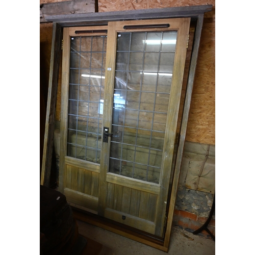 560 - A pair of hardwood lead glazed French doors and frame, 210 x 150 cm wide