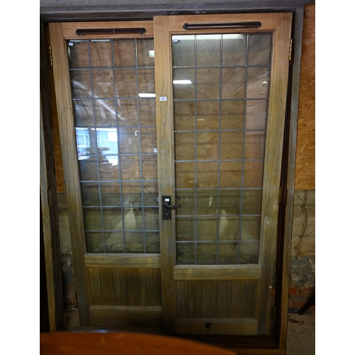 560 - A pair of hardwood lead glazed French doors and frame, 210 x 150 cm wide