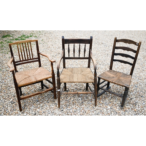 565 - # Two antique provincial rush seated carver chairs to/w single rocking chair (3)