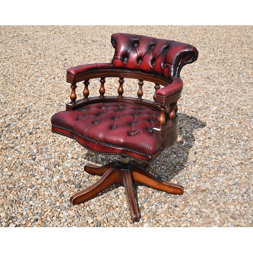 570 - Mahogany finish desk chair with red buttoned leather upholstery