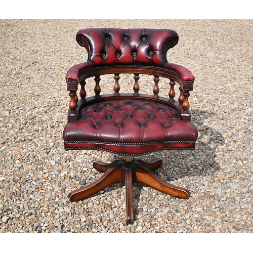 570 - Mahogany finish desk chair with red buttoned leather upholstery