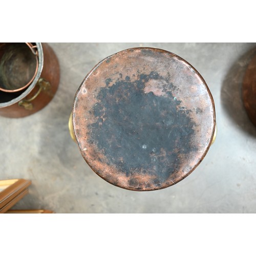 628 - A large hammered copper cylindrical vessel with brass handles to/w a hammered copper brass handled G... 