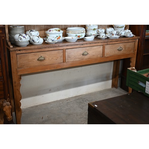 373 - A large antique pine dresser with plate rack over three drawer base with cupped handles and shaped s... 