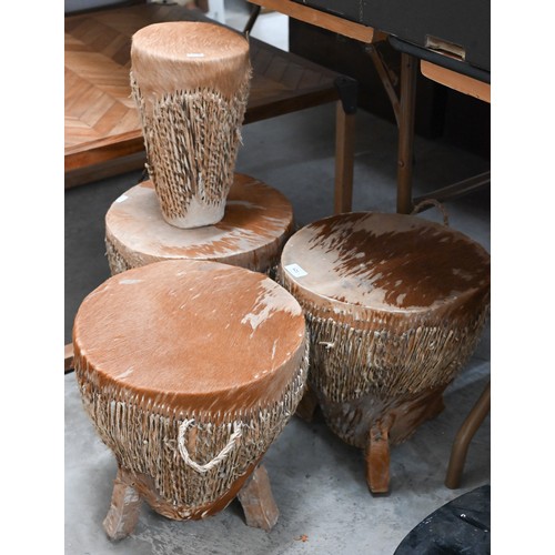 621 - A trio of traditional Ugandan/African drums, 33 cm diam to/w another 18 cm diam drum (4)