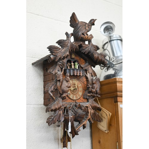 584 - A German Schneider carved wood cuckoo clock with revolving dancing couples below the cuckoo, above s... 