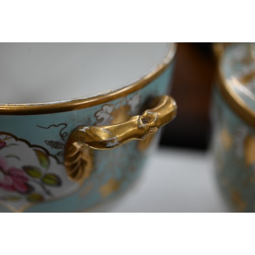 140 - Two early 19th century turquoise-ground and gilt covered urns, the reserves painted with floral spec... 