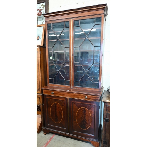 321 - A 19th century mahogany inlaid cabinet bookcase with astragal glazed doors over shallow drawer and p... 