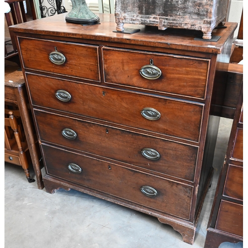 340 - A George III mahogany chest of two short over three long drawers with brass oval handles cast with s... 