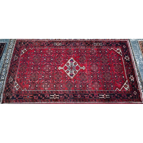 365 - An old Persian Hamadan kelleh carpet, the red ground with geometric garden design, 270 cm x 150 cm