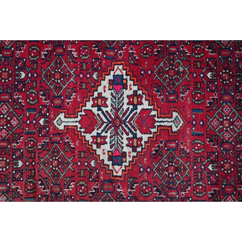 365 - An old Persian Hamadan kelleh carpet, the red ground with geometric garden design, 270 cm x 150 cm