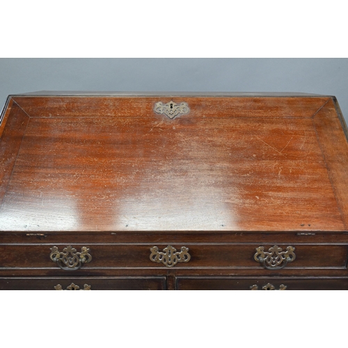 385 - A George III mahogany bureau, the fitted interior with slide top well over a dummy drawer, two short... 