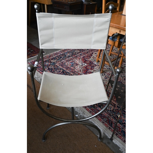 406 - A contemporary wrought metal armchair with fabric strung seat and back rest to/w wrought metal trian... 