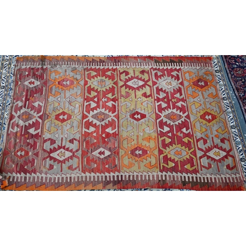 243 - A Turkish geometric design kelim in multi-colours, 253 cm x 167 cm