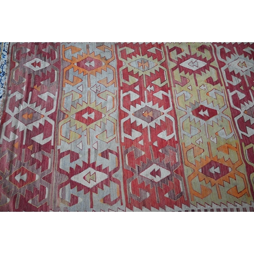 243 - A Turkish geometric design kelim in multi-colours, 253 cm x 167 cm