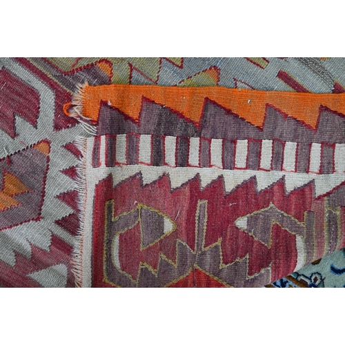 243 - A Turkish geometric design kelim in multi-colours, 253 cm x 167 cm