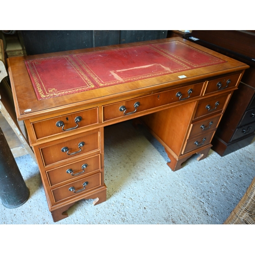 501 - A reproduction cherry finish twin pedestal desk, gilt tooled red leather top over nine drawers, 120 ... 