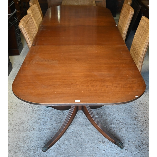 478 - A Regency style mahogany extending dining table with single wide central leaf on twin pedestal quadr... 