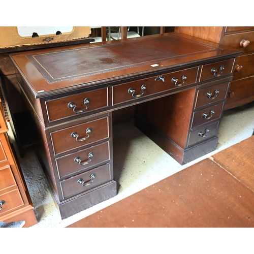 489 - A reproduction mahogany twin pedestal desk with gilt tooled brown leather top over nine drawers (wit... 