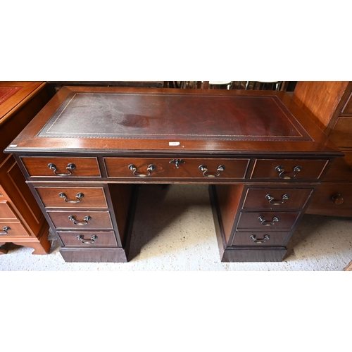 489 - A reproduction mahogany twin pedestal desk with gilt tooled brown leather top over nine drawers (wit... 