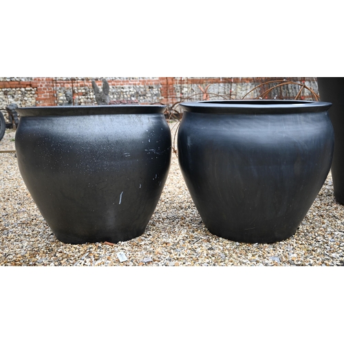 13 - A large black surface finished terracotta planter 70 cm dia. x 73 cm h to/with a smaller pair 57 cm ... 