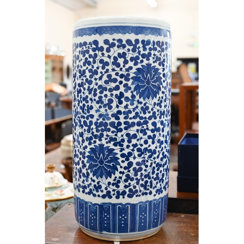 138 - A Chinese blue and white ceramic cylindrical stick-stand with floral and foliate decoration, 46 cm h... 