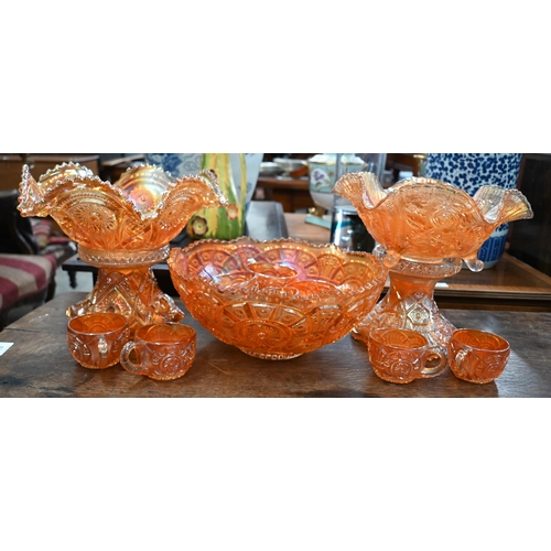 149 - Two Carnival glass punch-bowls on pedestals - one with eight matching glasses, to/w a similar fruit ... 