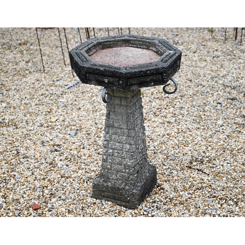 15 - A weathered reconstituted cast stone garden birdbath, the octagonal top on tapering base, 41 cm x 41... 