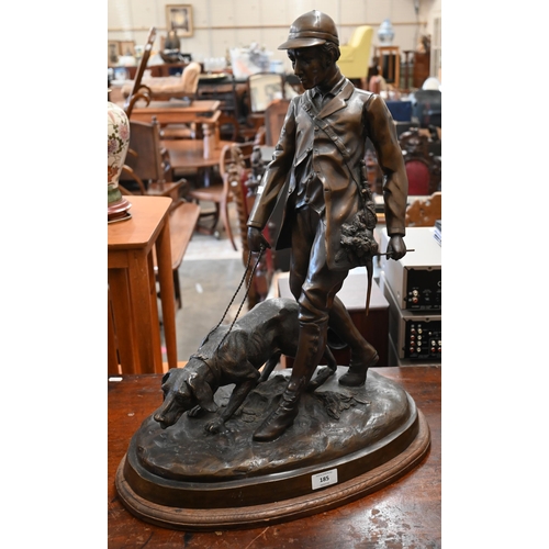 185 - A large Continental bronze group of a huntsman and dog, unsigned, 62 cm high on oval base