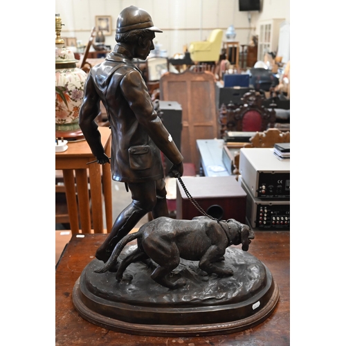 185 - A large Continental bronze group of a huntsman and dog, unsigned, 62 cm high on oval base