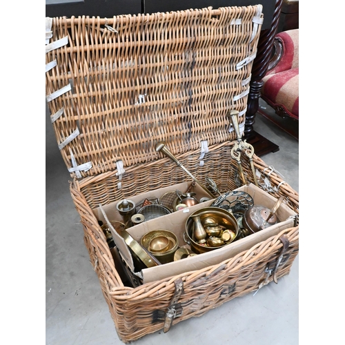 212 - A large  wicker laundry hamper containing a quantity of copper and brassware