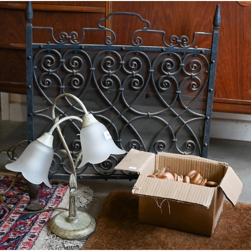 218 - # A wrought iron spark-guard, to/w a table lamp with two floral glass shades and a box of turned woo... 