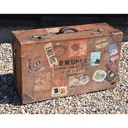 236 - A large vintage leather suitcase with various labels including Cunard White Star First Class and var... 