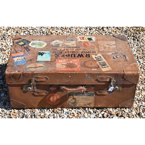 236 - A large vintage leather suitcase with various labels including Cunard White Star First Class and var... 