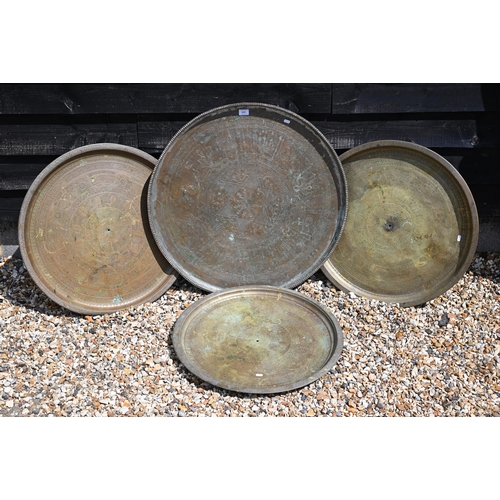 237 - Four large Eastern copper circular trays with engraved decoration