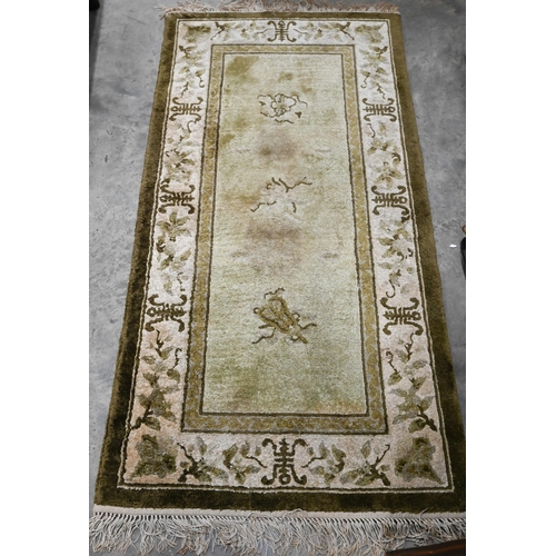 240 - # A small Chinese Peking style rug Shou symbols and auspicious motifs on green ground, 140 x 70 cm