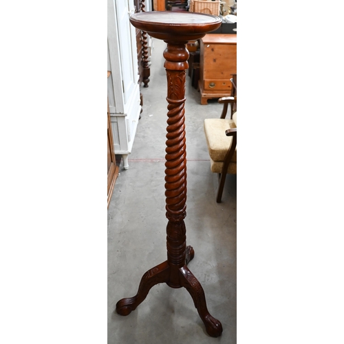 311 - A stained beech barleytwist torchere, 132 cm high