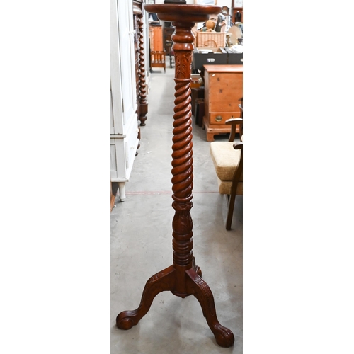 311 - A stained beech barleytwist torchere, 132 cm high