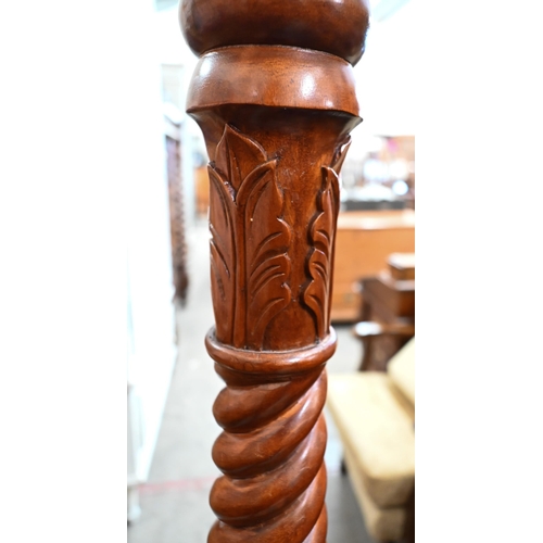 311 - A stained beech barleytwist torchere, 132 cm high