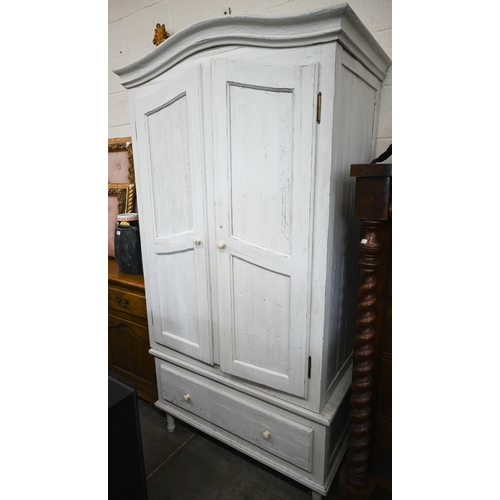 316 - A cream painted pine armoire wardrobe with panelled doors and single drawer (in two sections), by Lo... 