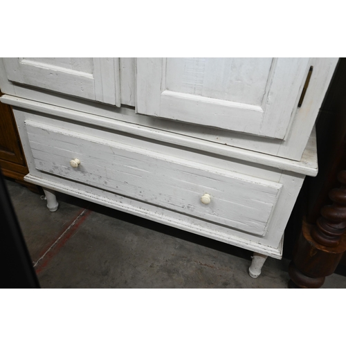 316 - A cream painted pine armoire wardrobe with panelled doors and single drawer (in two sections), by Lo... 