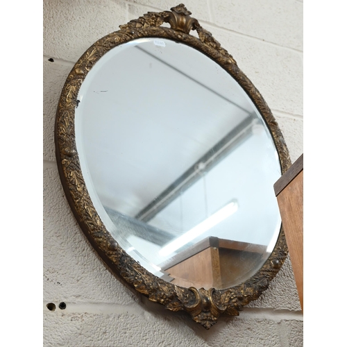 324 - A bevelled oval wall mirror in decorative gilt frame, 45 cm wide x 64 cm high to/w rectangular gilt ... 