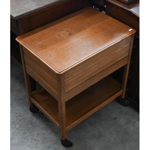 343 - Oak sewing table c/w 'Simplicity' patterns, box of buttons, threads, etc